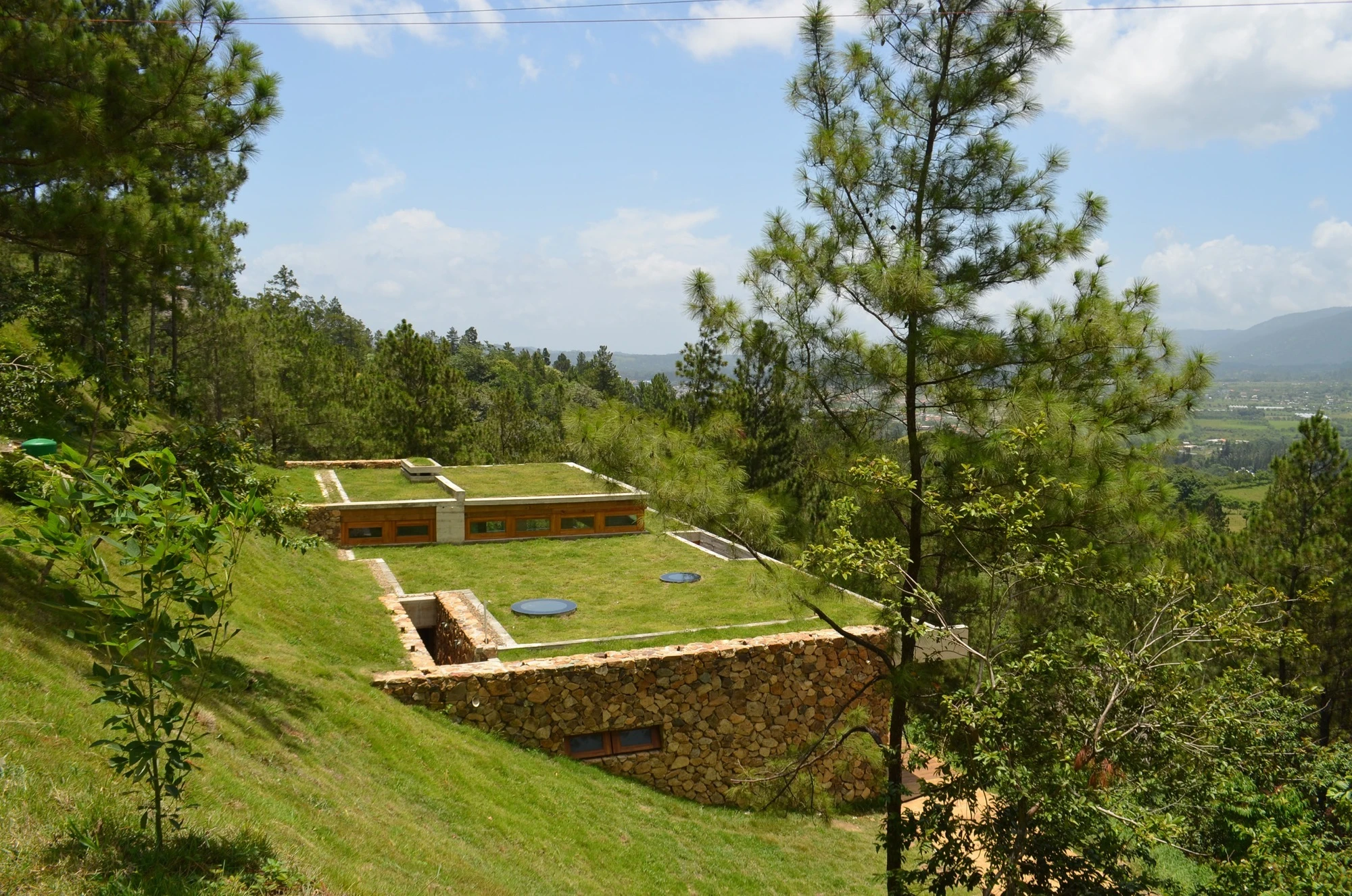 Multiple green roofs serve the dual purpose of helping the home blend into the hillside, and providing a degree of solar insulation (Photo: Eduardo Abreu)