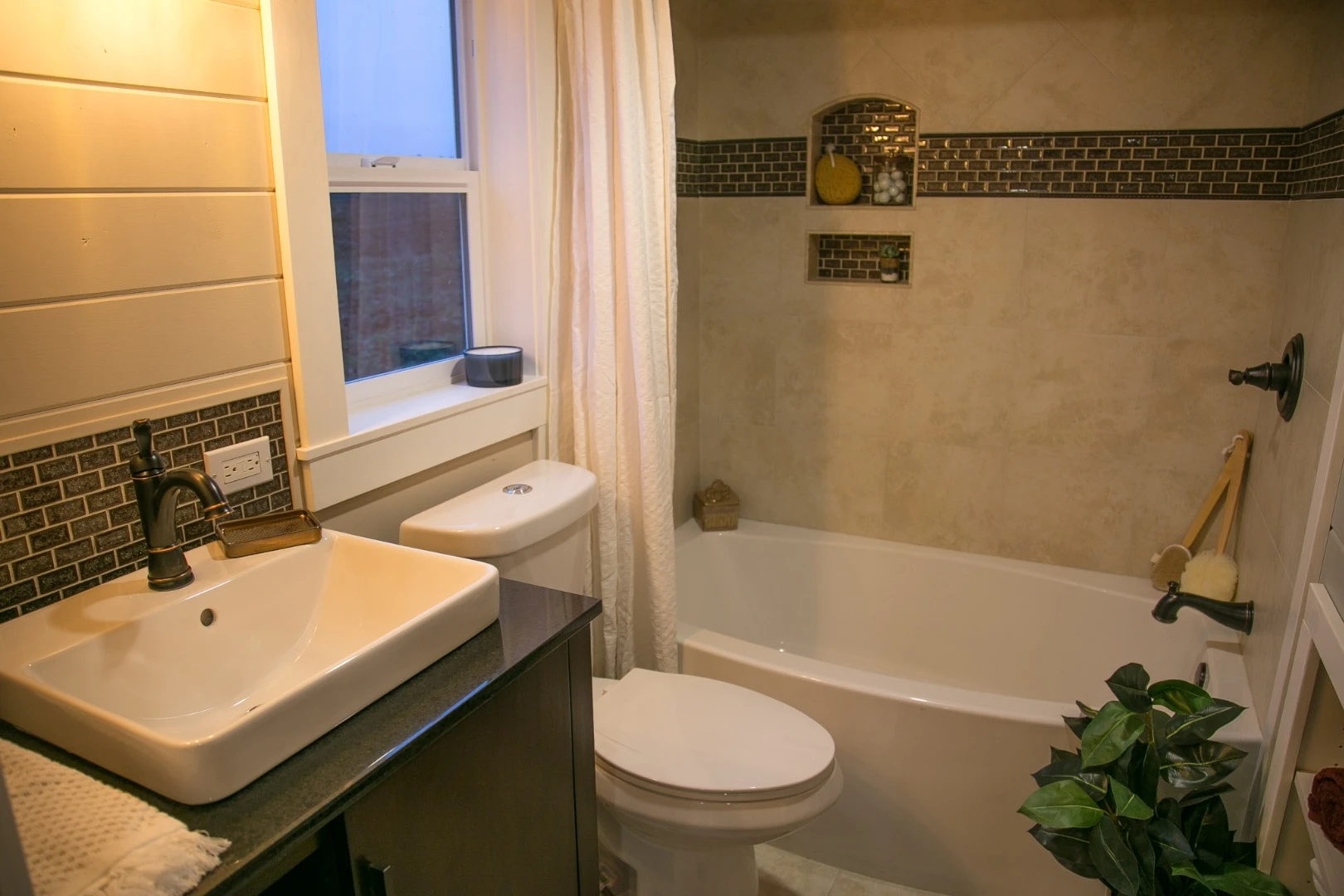 The Theater Home's bathroom includes a full-size bathtub/shower