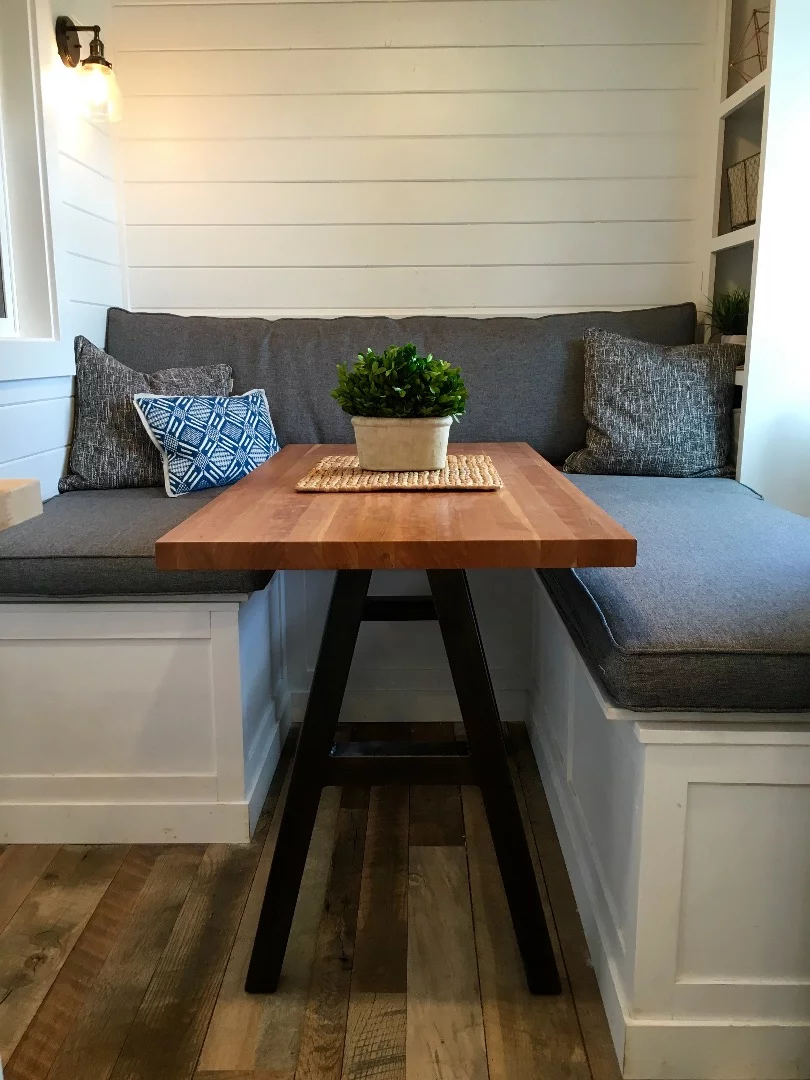 The Rocky Mountain Tiny Home's lounge includes a table on wheels for use as a dining table