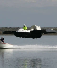 The "Hoverwing" home-made hovercraft-type vehicle on a test flight with a rescue vehicle in close proximity in New Zealand's south island (Photo: Marion van Dijk/Nelson)