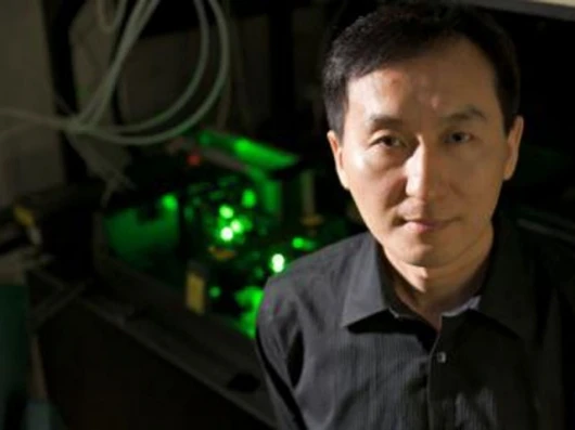 Chunlei Guo and the femtosecond laser usds to create nanostructures in metal that can move liquid uphillPhoto credit: Richard Baker, University of Rochester