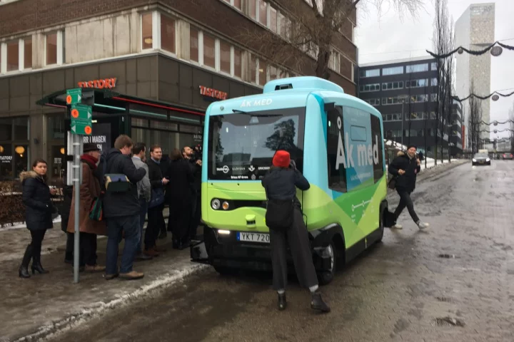 Some of the first passengers about to board one of the self-driving shuttle buses