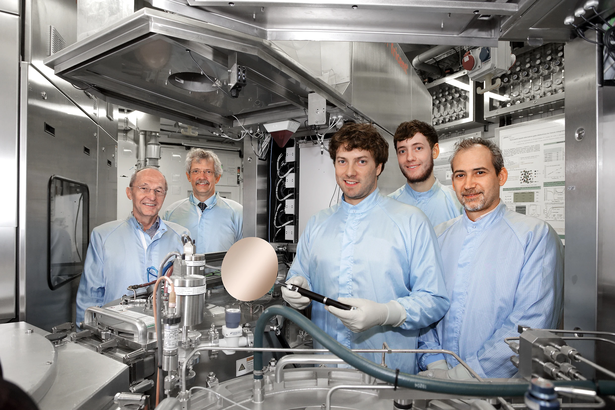 Scientists from the Peter Grünberg Institute (PGI-9) standing next to a CVD system which was used to prepare and develop parts of the new laser (from left: Prof. Siegrfried Mantl, Prof. Detlev Grützmacher, Stephan Wirths, Nils von den Driesch, and Dr. Dan Mihai Buca. (Photo: Forschungszentrum Jülich)