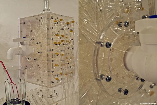 The results of the cocktail typewriter user's 'typing' are dispensed through a tap