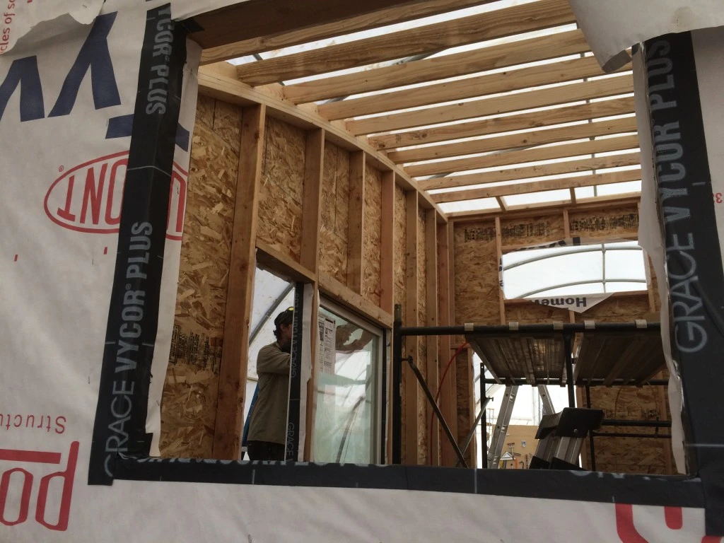The 16 Foot Curved Roof Tiny House features reclaimed cedar and tin siding