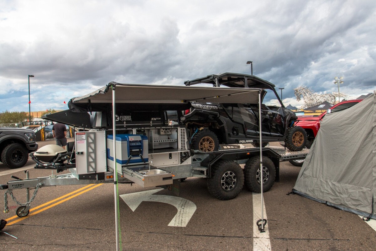 Patriot smashes together a boxy camper trailer and a toy-hauling cargo bed to create the TH730