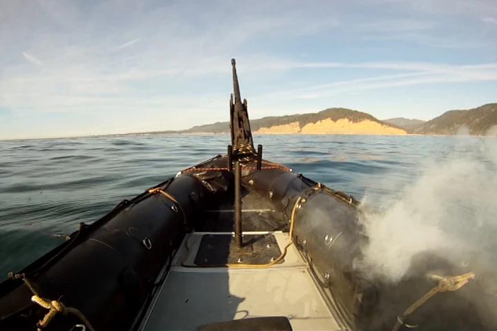 The Lockheed Martin ADAM laser system burns through the hull of a military-grade boat