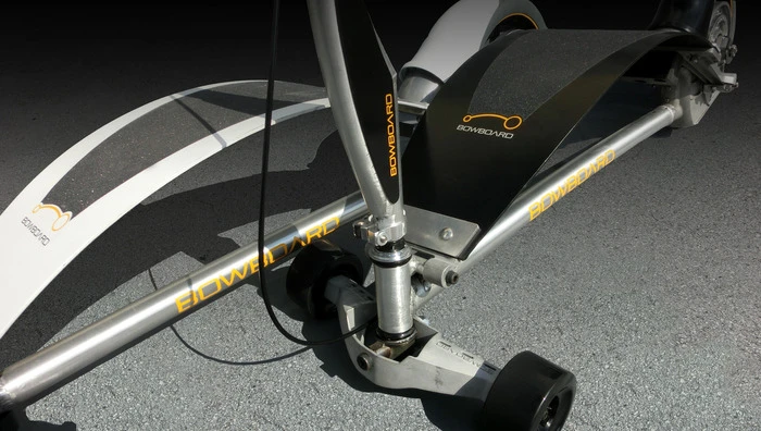 The Bowboard features an arced epoxy springboard above an aluminum alloy chassis