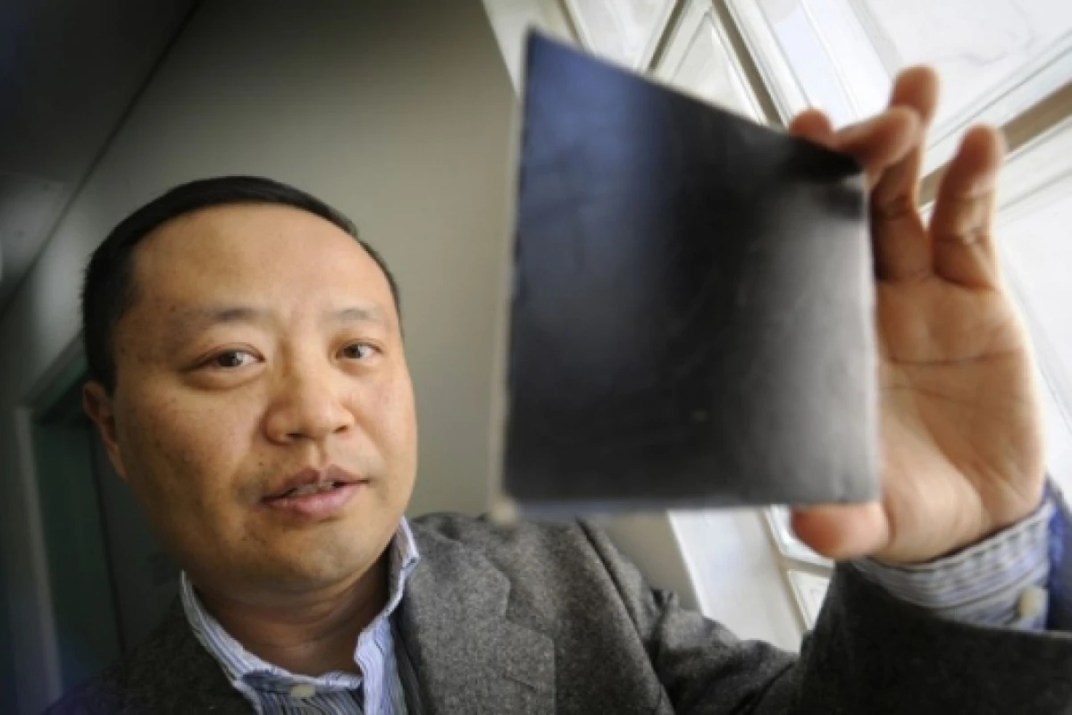 Dr Chan inspecting a small piece of the nanocomposite material.