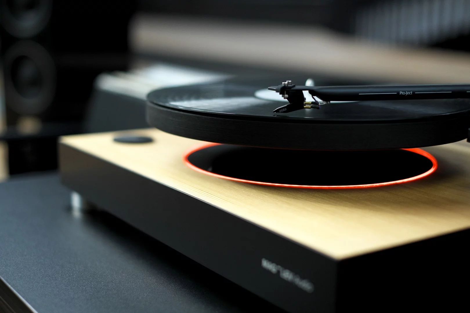 A funky orange glow emanates from the base below the platter of the Mag-Lev Audio turntable for no other reason than it looks cool