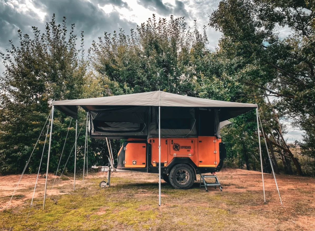 A large patio awning protects the kitchen and leaves space for outdoor dining in the shade