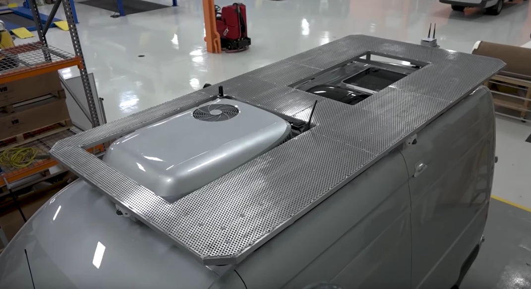 The custom roof rack doubles as a deck for relaxing at camp