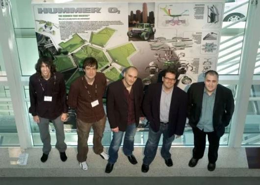 Members of the General Motors' West Coast Advanced Design Studio team stand with a graphic of their winning entry, the HUMMER O2 Concept. Members of the team include (l to r) Loren Kulesus, Jussi Timonen, Jose Paris, Steve Anderson and GM West Coast Advan