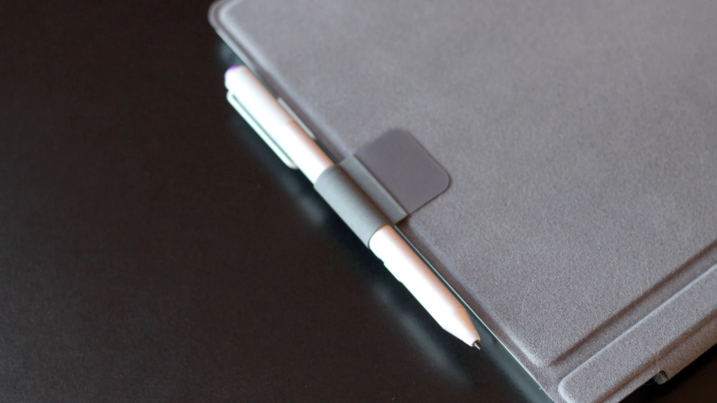 The Type Cover now has a little loop (which you have to attach yourself) that you can slide the pen into