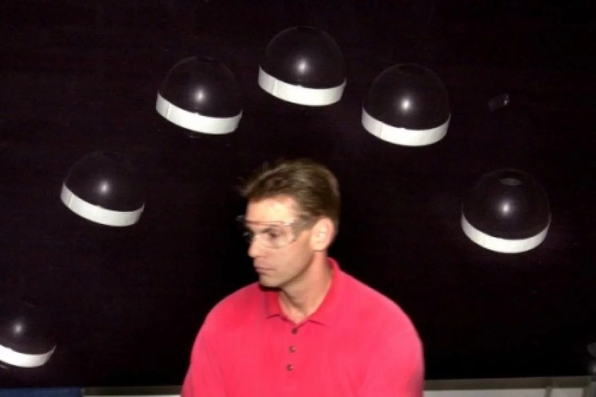 A hopping robot jumps over the head of Sandia National Laboratories researcher Gary Fischer (Photos: Randy Montoya)