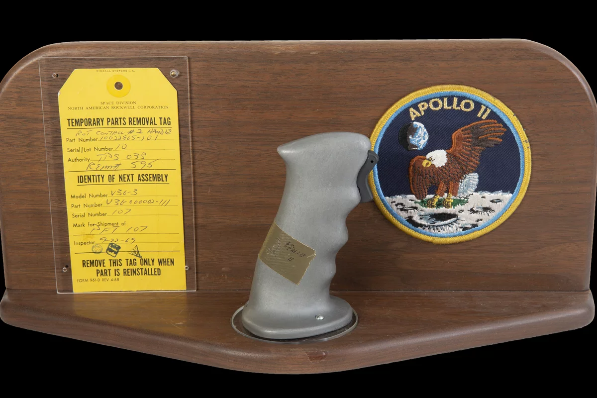 $370,000 | Neil Armstrong's Apollo 11 Control Joystick | Julien's Auctions | Estimate: $100,000 - $200,000 | 18 July 2020 | The original rotational attitude control stick (aka rotation hand controller) from the Apollo 11 command module Columbia in 1969. This control handle, located near the right hand of astronaut and mission commander Neil Armstrong (positioned in the left couch of the command module) allowed navigation of the spacecraft's attitude using roll, pitch, and yaw adjustments. The control stick is fitted with a trigger switch for activating the headset microphone. Included is a wooden display mount with an Apollo 11 mission patch and the original parts removal tag (dated September 22, 1969) with matching serial numbers and official NASA stamps. Part number 10022865-101. Serial number 10. NOTE: The provenance of this item has been corroborated by an official NASA audit report published by the Office of Inspector General in 2018.