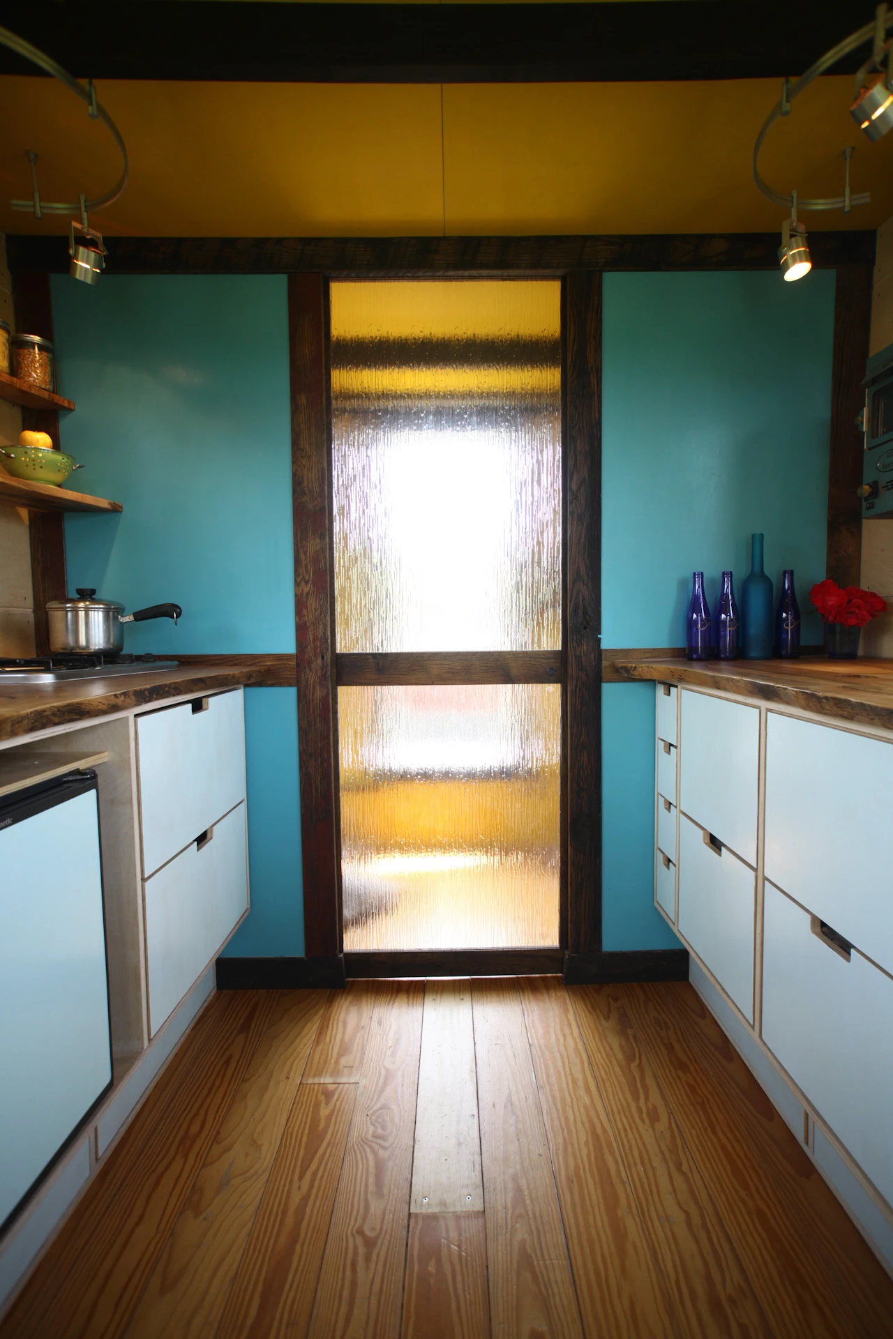 Pocket Shelter features a sliding glass pass-through door and a bathroom with a mini built-in composting toilet