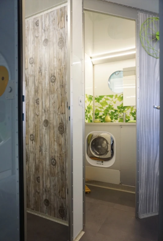 The washing machine is located in the bathroom area