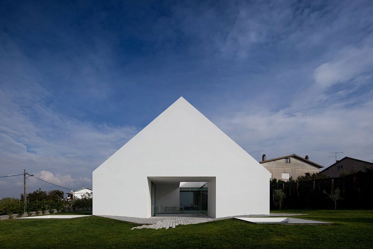 From Aires Mateus Architects this home is simple called ‘House In Leiria’. Almost all of the house is built underground with a doorless, and windowless monolithic impression of a house standing above the ground