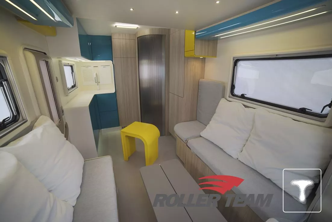 The yellow stool nests neatly around the under-bench drawer