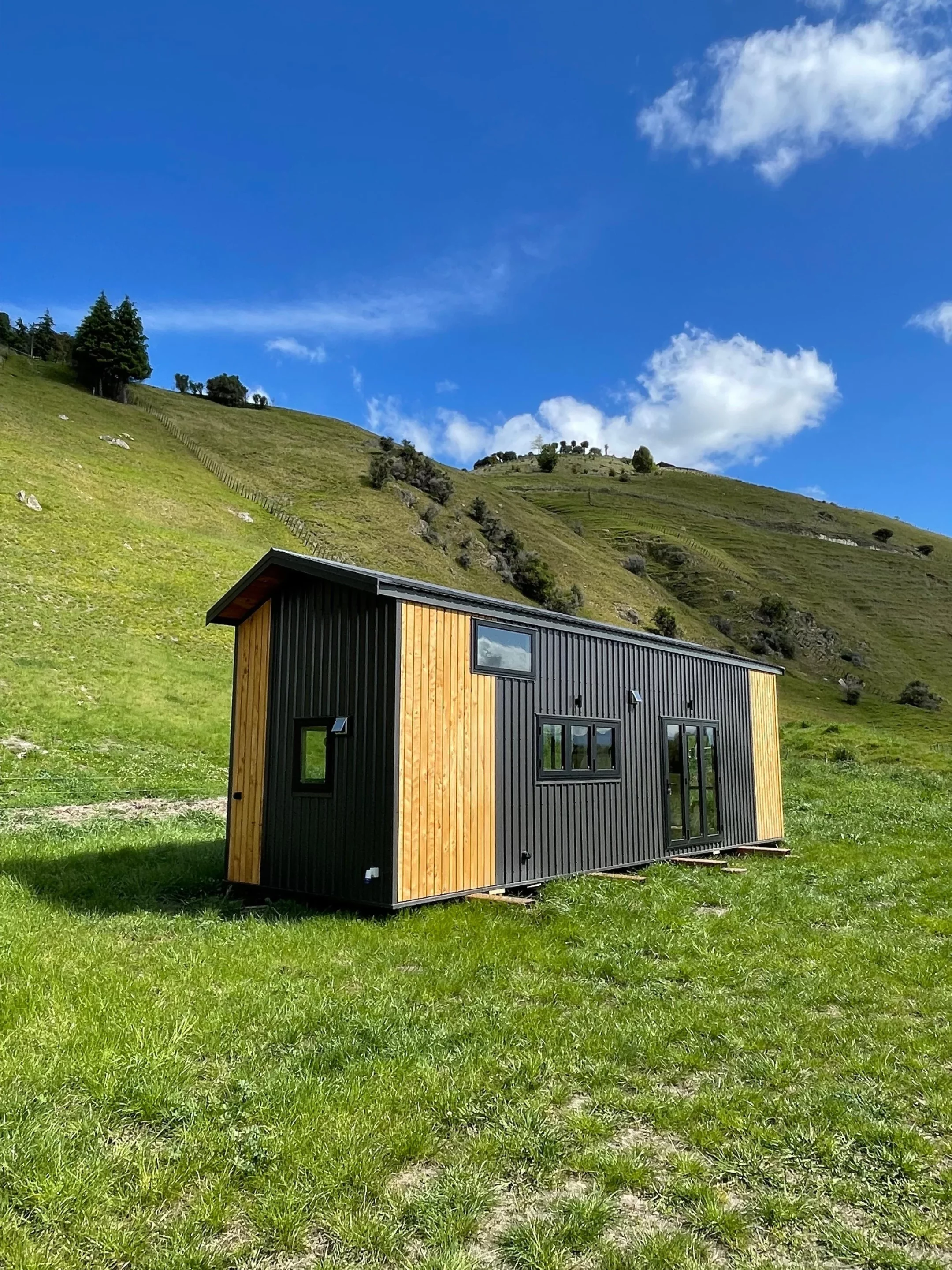 The Redwood's exterior is finished in painted steel, with Macrocarpa timber accents, and is topped by a metal roof