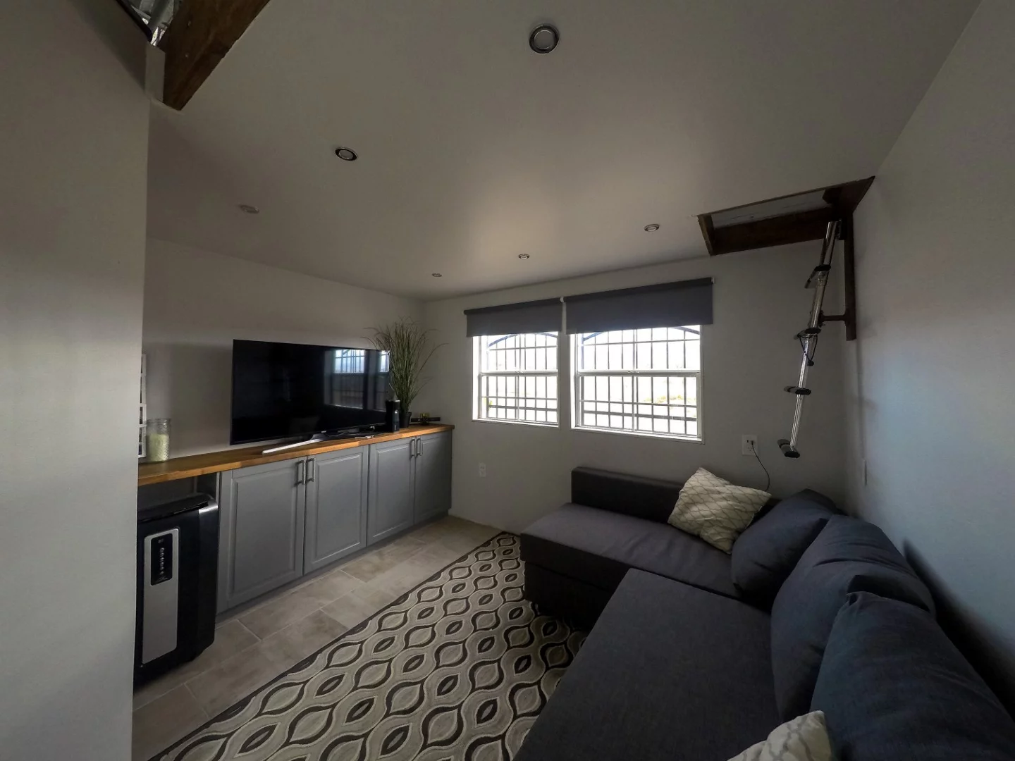 The living room with every modern day amenity, including an Xbox. You can access one of the two loft style bunks via the ladder.