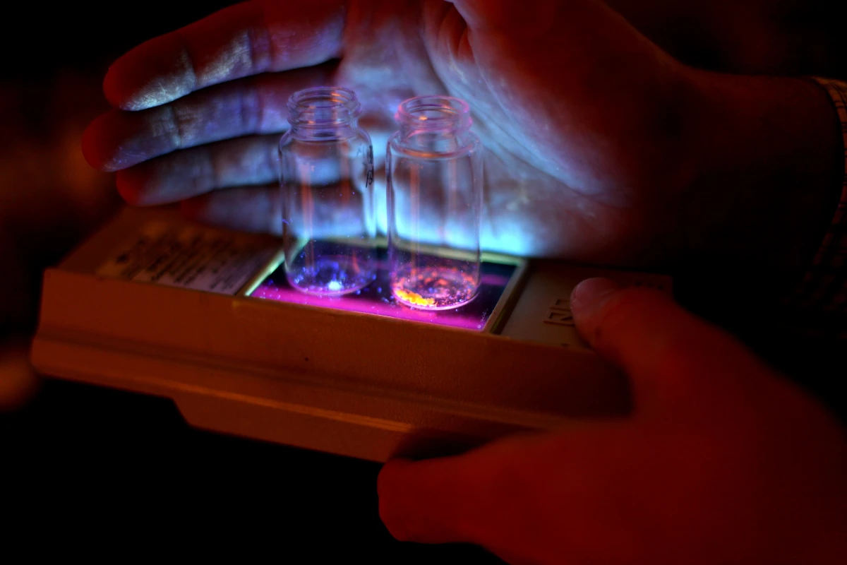 The new phosphors glow in blue and orange when triggered by ultraviolet light (Photo: Marcin Szczepanski, U-M College of Engineering)