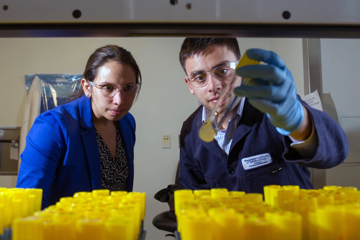 Georgia Tech researchers Pamela Peralta-Yahya and Stephen Sarria examine the production of the hydrocarbon pinene in laboratory test tubes (Photo: Georgia Tech/Rob Felt)