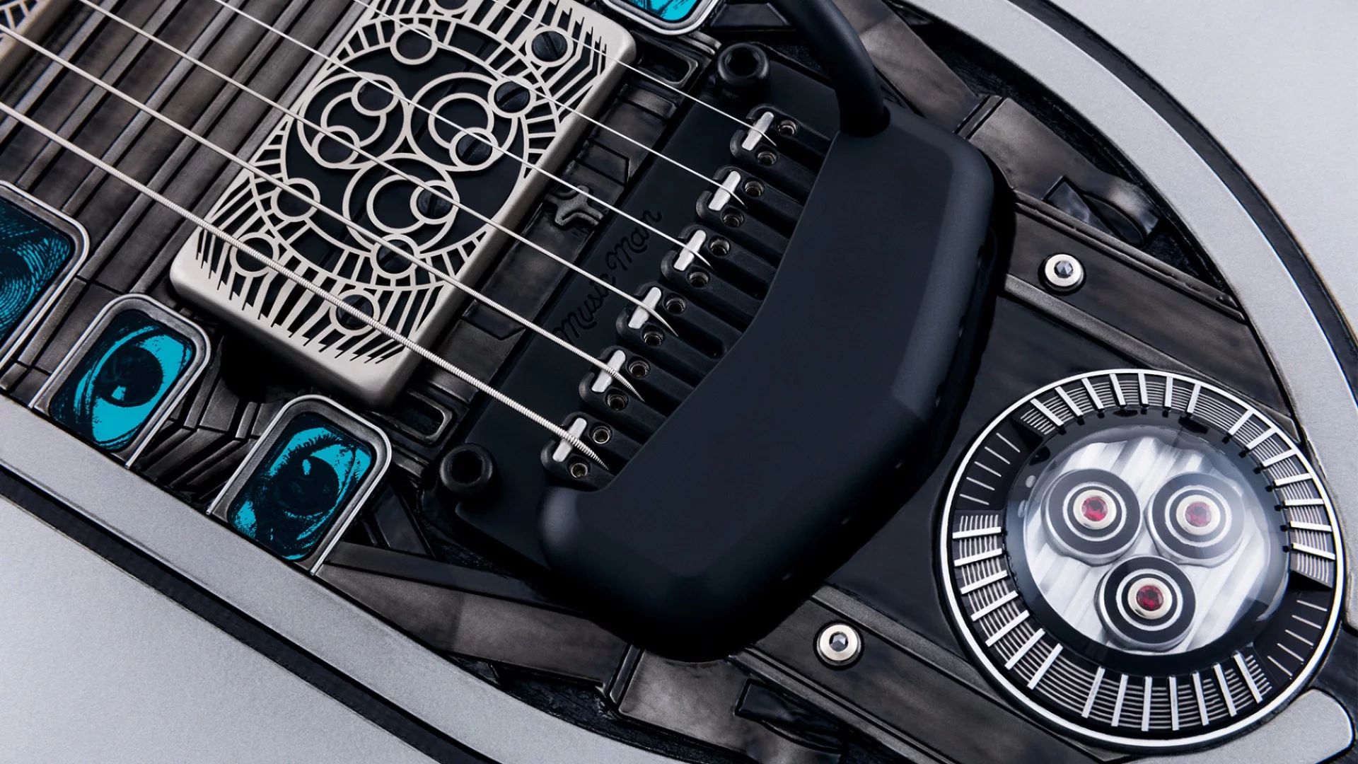 The Nomac Majesty has three backlit rubies set in white gold and mounted on a machined aluminum medallion behind the piezo bridge tremolo light up when the cable is plugged in