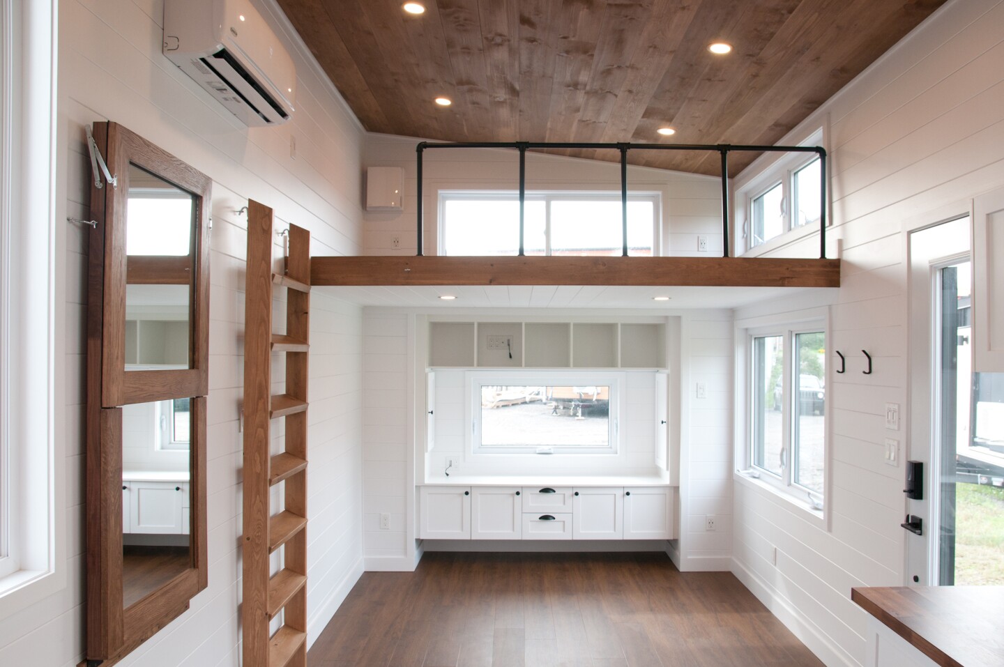 The Ébène V3's living room has a large entertainment center with built-in storage space