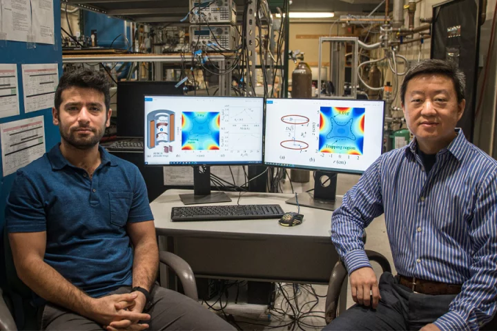 Doctoral student Hamid Sanavandi (left) and Associate Professor Wei Guo, co-atuhors on a paper that describes a new design for a magnetic levitation-based simulator that creates a low-gravity environment.(Stephen Bilenky/National MagLab)