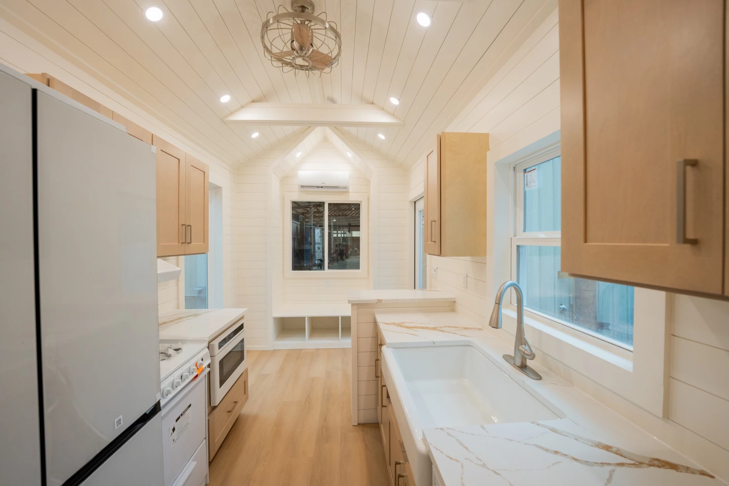 The main entrance opens onto the living room, which is compact and contains some storage, plus some space for a TV and sofa