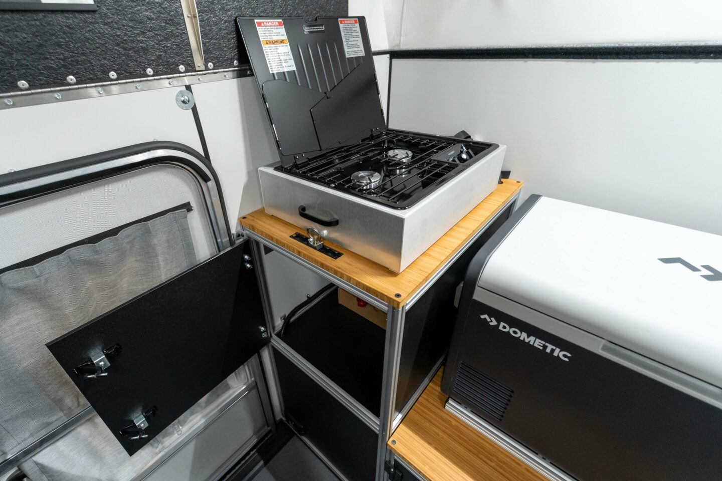 The other standard module, the utility module is designed to house the propane tank in one cabinet and offer a second storage cabinet; it also serves as the base for the available dual-burner gas stove