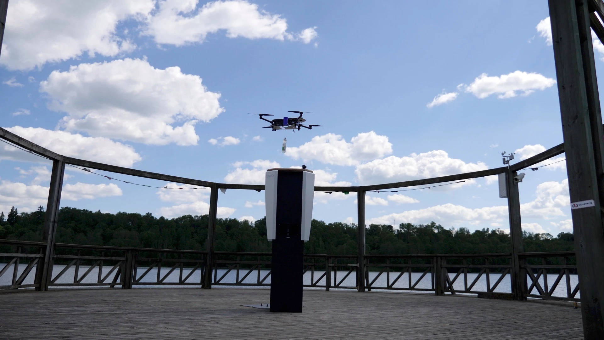 A quadcopter drops a bottled beverage into the CleverNest