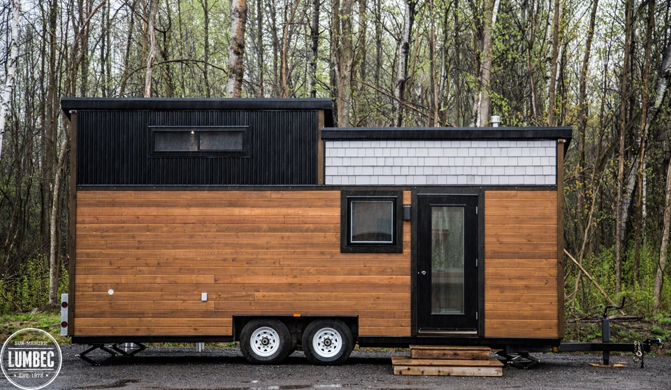 The tiny house is clad in white pine, stained western red cedar, and steel