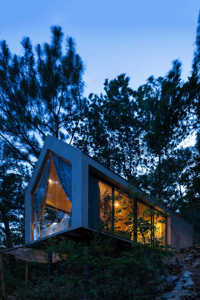 Forest House 02 is surrounded by vast forest landscape in the Sóc Sơn District, 30.6 km (19 mi) outside of Hanoi, Vietnam