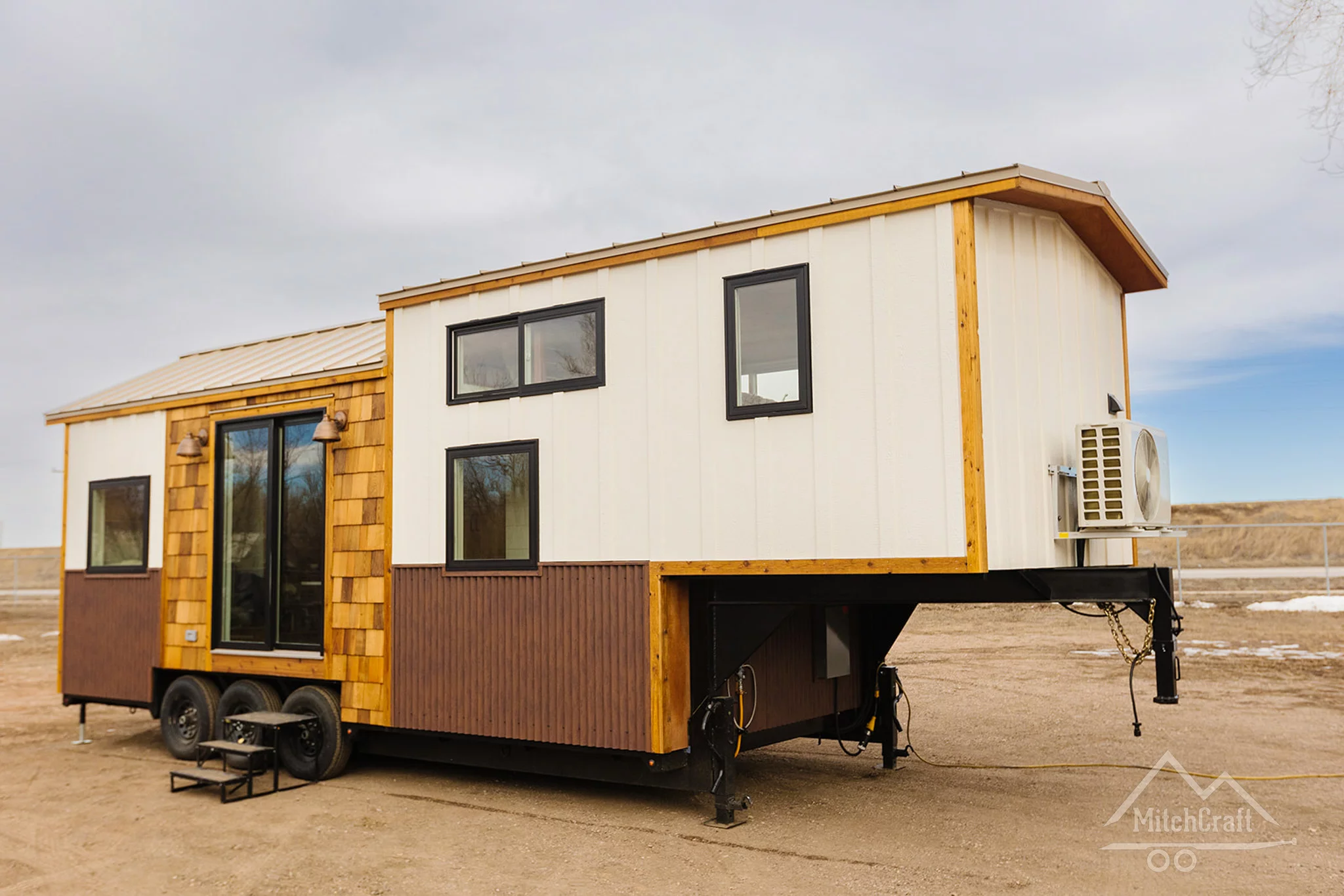 The CC 31' x 10' is finished in a mixture of painted board and batten, with corrugated siding and cedar accenting