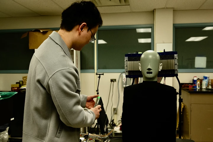 Postdoctoral scholar Jia-Xin "Jay" Zhong prepares to test the "audible enclave" technology on a mannequin