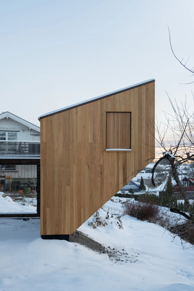 The leaning lounge structure playfully balances on stainless steel supports