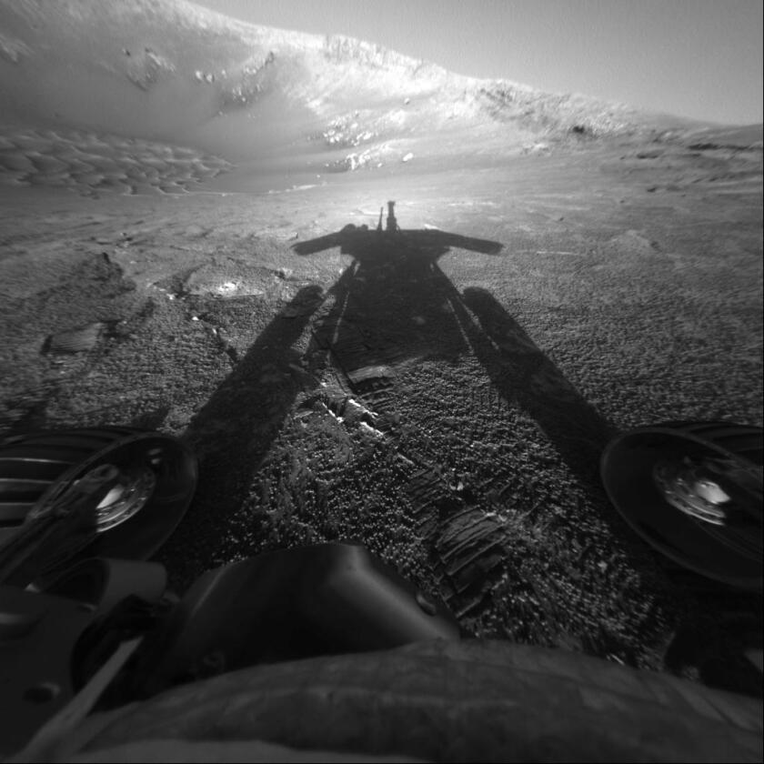 A photo of NASA's Mars Exploration Rover Opportunity's shadow was taken on sol 180 (July 26, 2004) by the rover's front hazard-avoidance camera