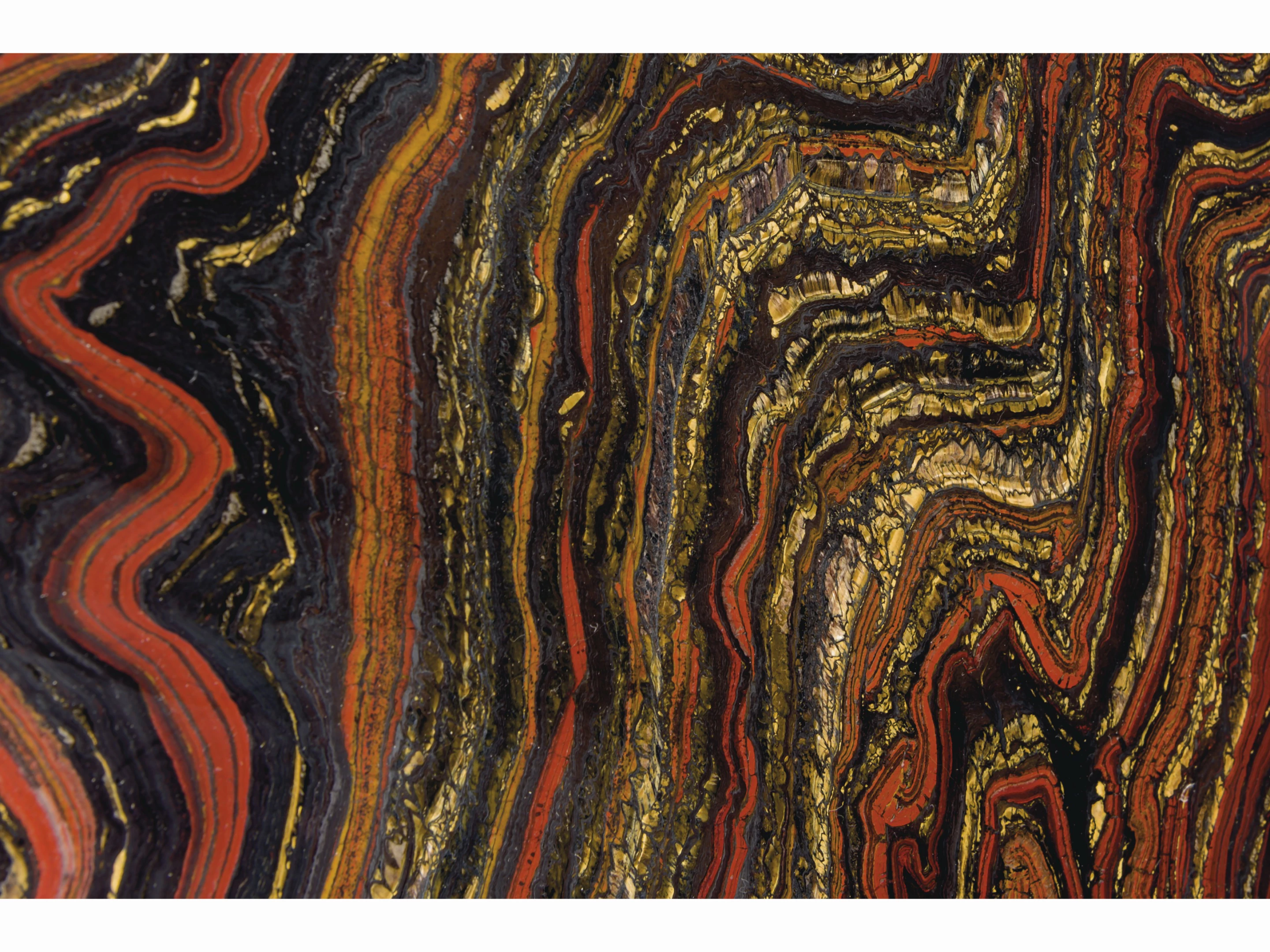 33-inch diameter "table top" 2.5cm thick specimen of banded layers of hematite, jasper and chatoyant Tiger-eye from the Paleoproterozoic (2.5 to 1.6 billion years ago) | Sold for: $12,997 (£10,000) by Christie's on October 28, 2020