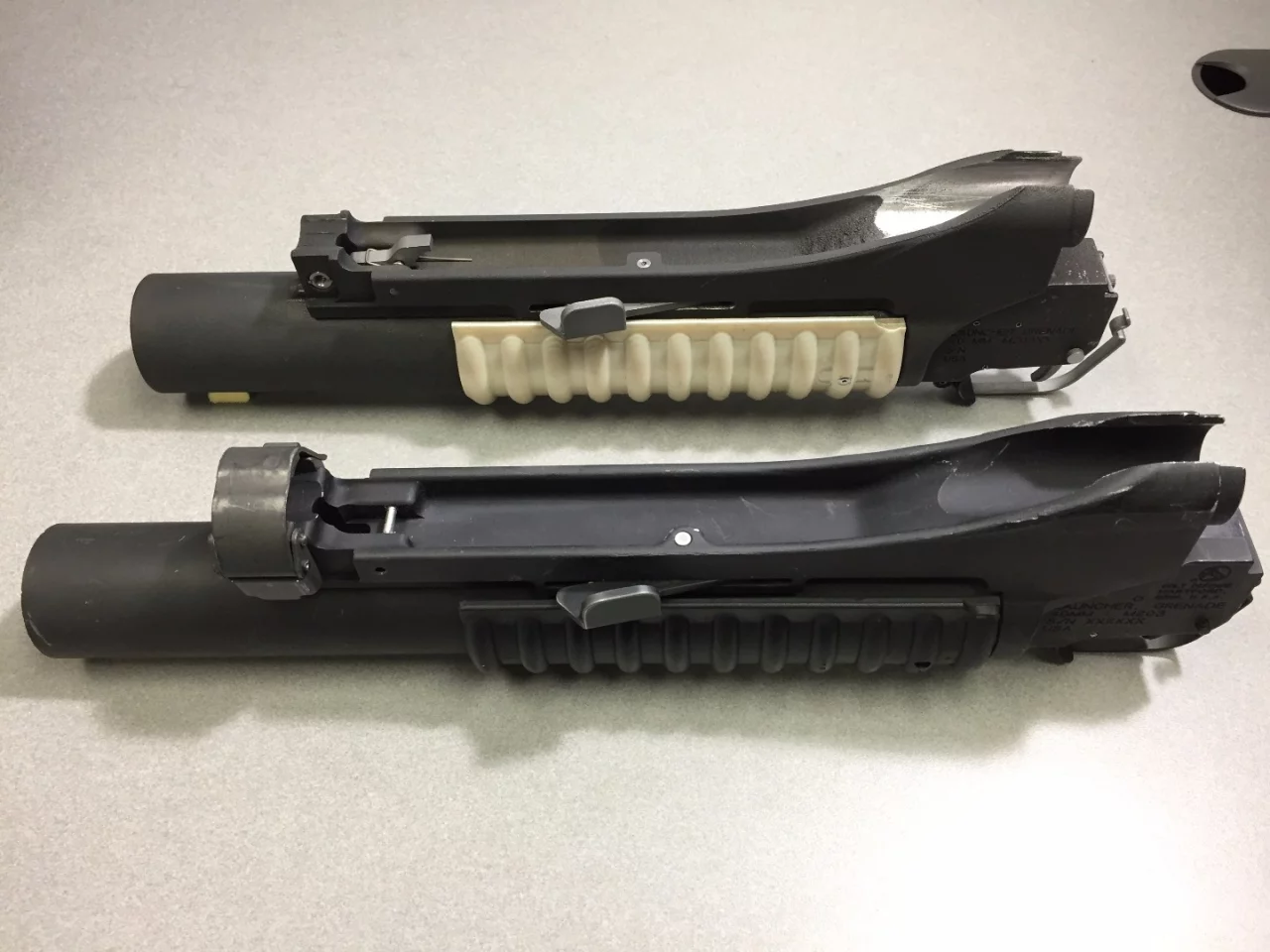 More than 90 percent of the components in the prototype grenade launcher, top, were printed with AM, in just 35 hours and on a single build plate