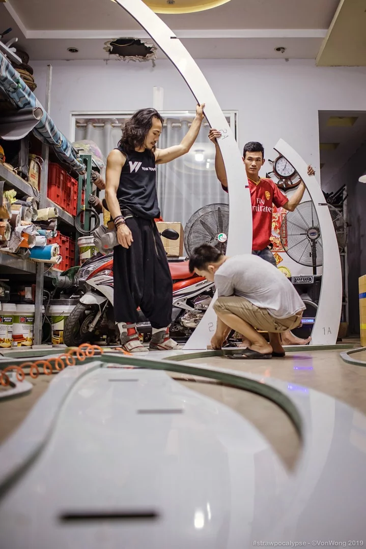 Canadian artist Benjamin Von Wong at work on his Strawpocalypse installation