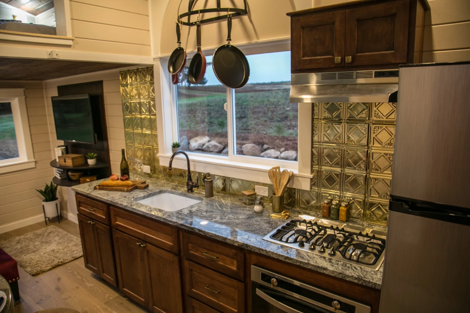 The Theater Home's kitchen includes full-size stainless steel appliances and a three-burner propane-powered stove, as well as an oven