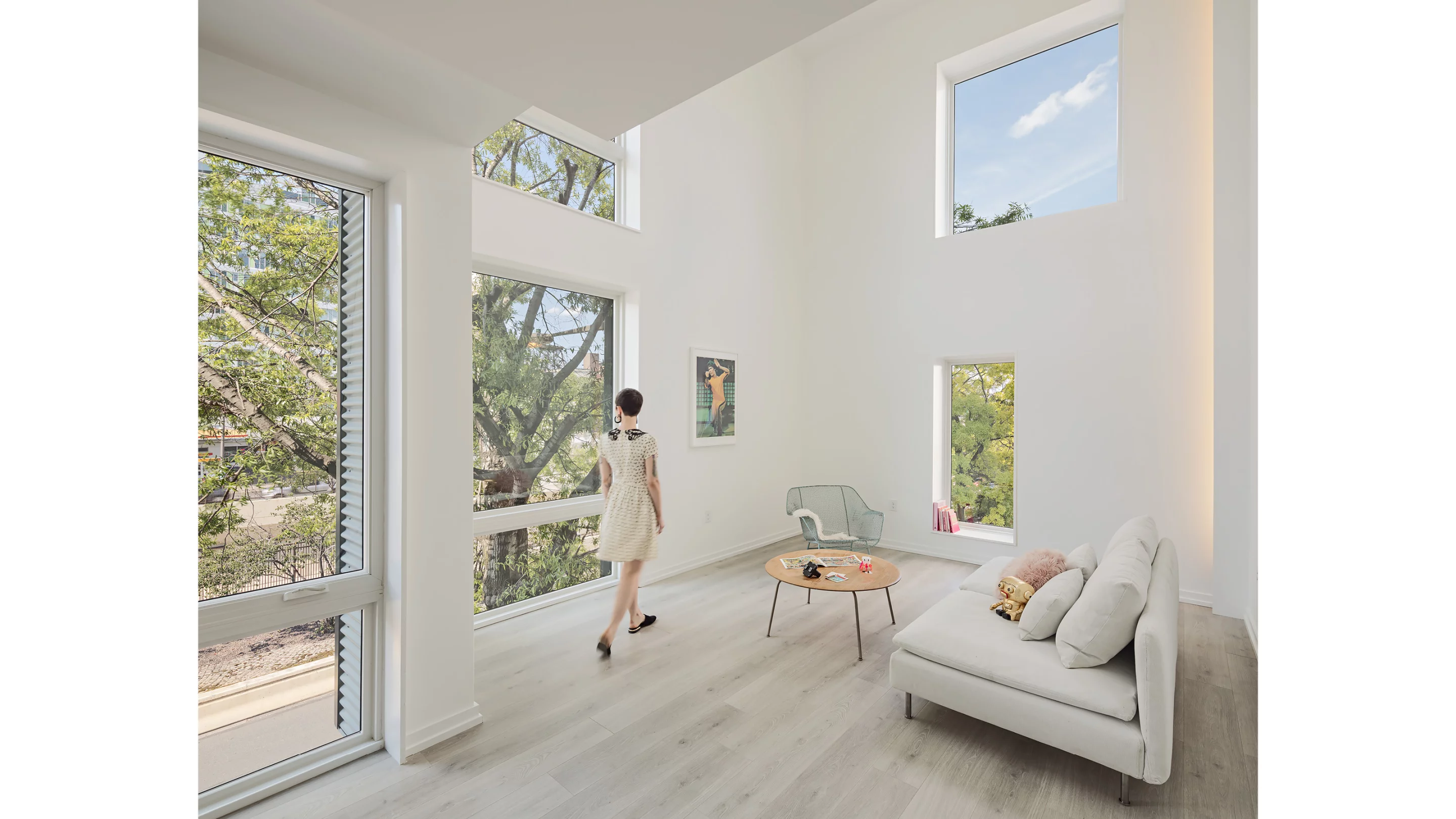 Despite its cramped dimensions, the interiors of XS House's apartments look very livable, with high ceilings and ample daylight, plus a minimalist interior decor that suits the small space