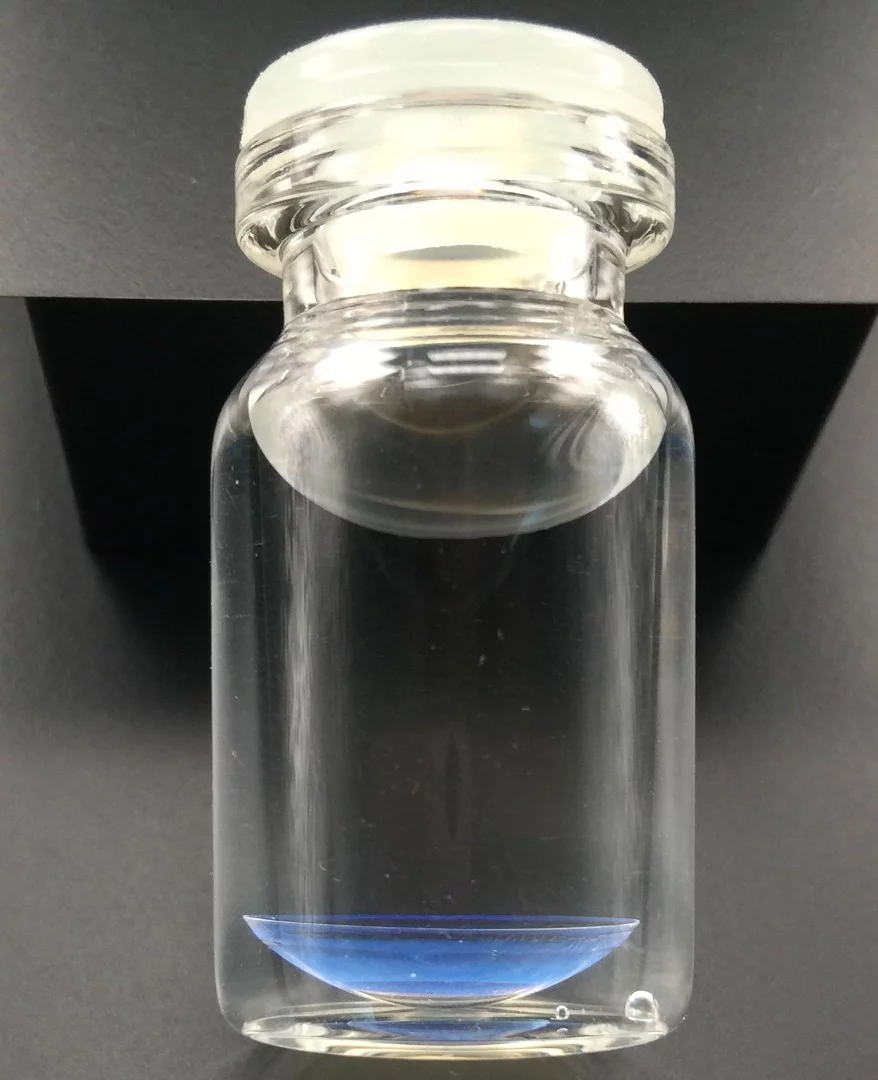 One of the prototype color-changing contact lenses, in the bottom of the flask
