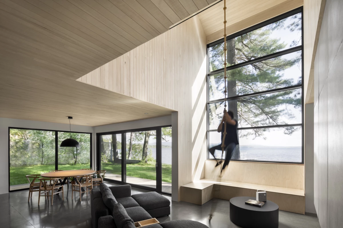 The Lakeside Cabin's living area features a climbing rope hanging from the ceiling