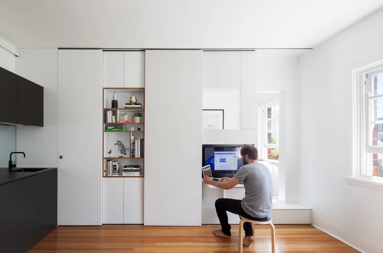 The 27-square meter (290-sq ft) apartment was transformed into a multi-functional home that comfortably accommodates two