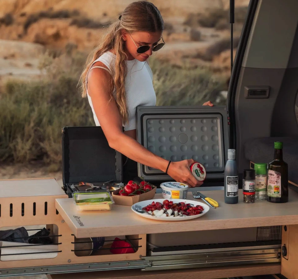 The compact fridge is accessible from either side, adding to the kitchen versatility