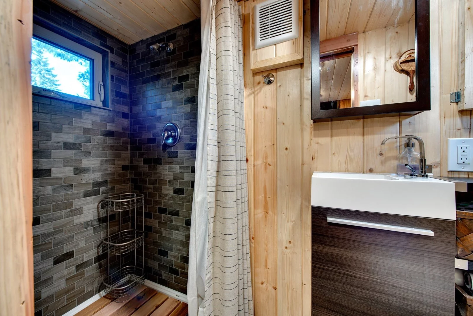 The shower has been titled and outfitted with a custom cedar floor
